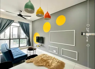 a living room with a blue chair and yellow circles on the wall at Mid Valley - Vivo Residence Center Of KL 6-8Pax in Kuala Lumpur