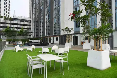 a group of tables and chairs on grass in a building at Mid Valley - Vivo Residence Center Of KL 6-8Pax in Kuala Lumpur