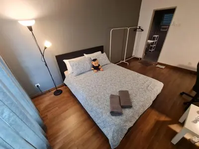 a teddy bear sitting on a bed in a bedroom at 1 min Next to LRT CHERAS 68 with Shared Area in Kuala Lumpur
