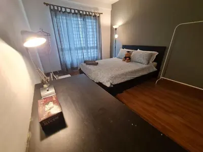 a bedroom with a bed with a teddy bear on it at 1 min Next to LRT CHERAS 68 with Shared Area in Kuala Lumpur