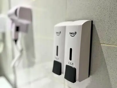 a soap dispenser on a wall in a bathroom at Smile Hotel Cheras Sri Permaisuri in Kuala Lumpur