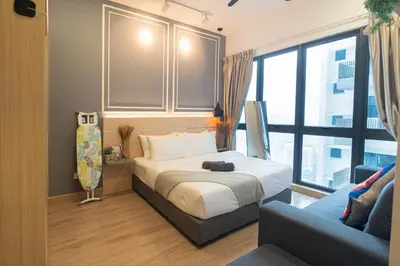 a bedroom with a bed and a couch and a window at The Colony By Infinitum Best Pool View KLCC TRX Merdeka 118 KL Tower in Kuala Lumpur