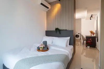 a bedroom with a bed with a tray of flowers on it at The Colony By Infinitum Best Pool View KLCC TRX Merdeka 118 KL Tower in Kuala Lumpur