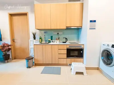 a kitchen with a washing machine and a washer at The Colony By Infinitum Best Pool View KLCC TRX Merdeka 118 KL Tower in Kuala Lumpur
