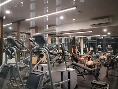 a gym with several people exercising on tread machines at Orion Suites@ The Robertson Bukit Bintang in Kuala Lumpur