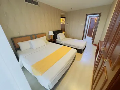 a hotel room with two beds and a window at Times Square East privite service Apartment in Kuala Lumpur