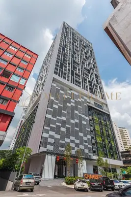 a tall building with a sign on the side of it at Chambers Premier Suites Kuala Lumpur in Kuala Lumpur