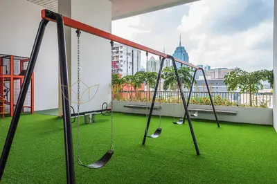 a play area with swings on a balcony at Chambers Premier Suites Kuala Lumpur in Kuala Lumpur