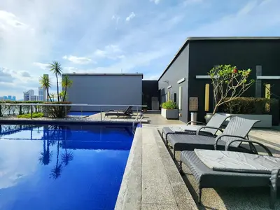 a swimming pool with lounge chairs next to a building at 1-6px Bukit Bintang 1min walk to Lot10 Pavilion in Kuala Lumpur