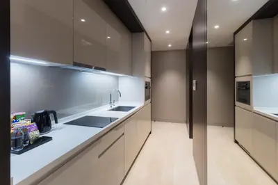 a kitchen with white cabinets and a sink at Atelier Bukit Bintang in Kuala Lumpur