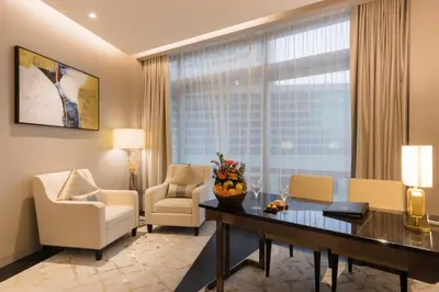 a living room with a desk and chairs and a window at Atelier Bukit Bintang in Kuala Lumpur