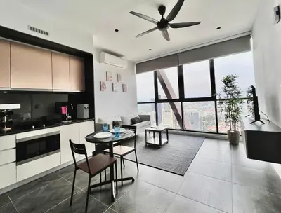a kitchen with a table and a ceiling fan at Scarletz KLCC Apartments by soulasia in Kuala Lumpur