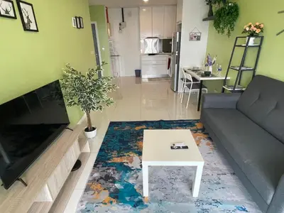 a living room with a couch and a coffee table at Mercu Summer Suite KLCC by Minshuku in Kuala Lumpur