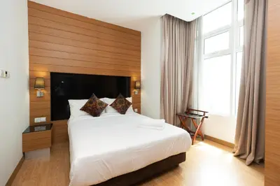 a hotel room with a large bed and a large window at Dua Sentral Residence near KL Sentral by COBNB in Kuala Lumpur