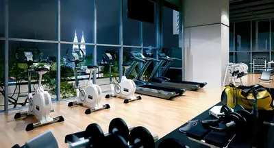a gym with several treadmills and machines in it at Premium Suites by Home Horizon at Lucentia Residence in Kuala Lumpur