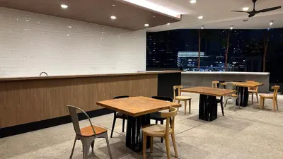a restaurant with wooden tables and chairs and a counter at The Robertson Residence Bukit Bintang 20F in Kuala Lumpur