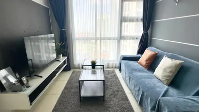 a living room with a blue couch and a table at The Robertson Residence Bukit Bintang 20F in Kuala Lumpur