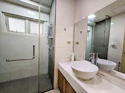 a bathroom with a sink and a glass shower at Crest Residence Klcc by Sarah's Lodge in Kuala Lumpur