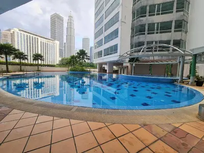 a large swimming pool in the middle of a city at Crest Residence Klcc Bukit Bintang by Sarah's Lodge in Kuala Lumpur
