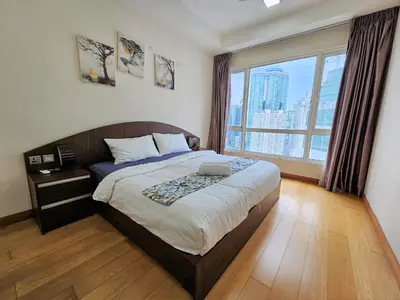 a bedroom with a large bed and a large window at Crest Residence Klcc Bukit Bintang by Sarah's Lodge in Kuala Lumpur