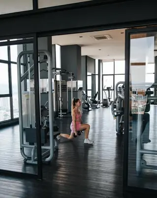 a woman is sitting on a treadmill in a gym at EXPRESSIONZ KLCC BY MANA-MANA in Kuala Lumpur
