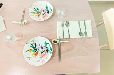 a table with plates and utensils on it at Massive KL View at M-Vertica by HCK in Kuala Lumpur