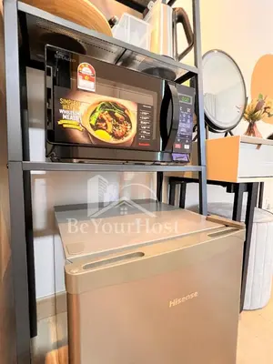a microwave oven sitting on top of a shelf at The Colony by Infinitum Kuala Lumpur in Kuala Lumpur
