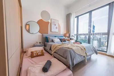 a bedroom with two beds and a large window at The Colony by Infinitum Kuala Lumpur in Kuala Lumpur