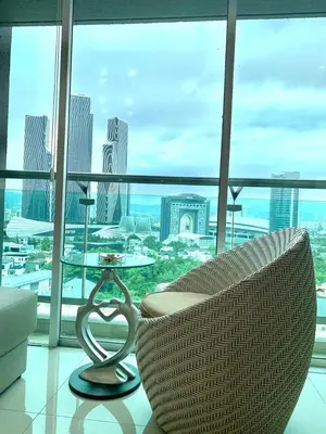 a glass table and a chair in a room with a view at MITEC Publika 2Br Hot tub Sri Hartamas Mont Kiara in Kuala Lumpur