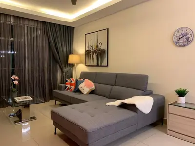 a living room with a couch and a table at MITEC Publika 2Br Hot tub Sri Hartamas Mont Kiara in Kuala Lumpur