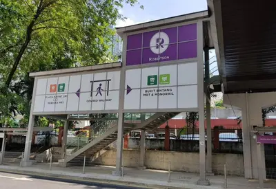 a building with a sign with arrows on it at S31- 3 Bedroom Robertson at Bukit Bintang with Netflix in Kuala Lumpur