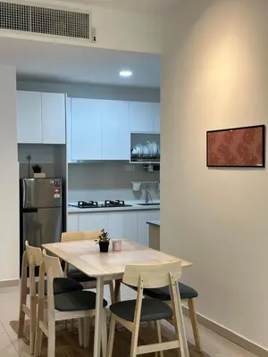 a kitchen with a wooden table and chairs at KLCC Kampung Baru Cottage - Homestay in Kuala Lumpur