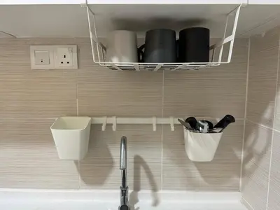 a bathroom with a sink and a shelf with pots and pans at KLCC Kampung Baru Cottage - Homestay in Kuala Lumpur