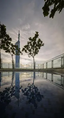 a reflection of a clock tower in a pool of water at S36- Robertson at Bukit Bintang 3 Bedroom with Netflix in Kuala Lumpur