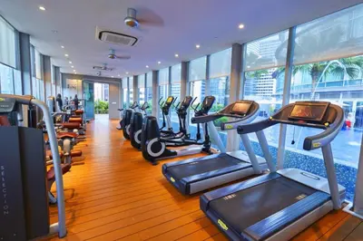 a gym with rows of treadmills and elliptical machines at Luxury 2BR Home in Vortex Stunning KL Tower View Free WiFi in Kuala Lumpur