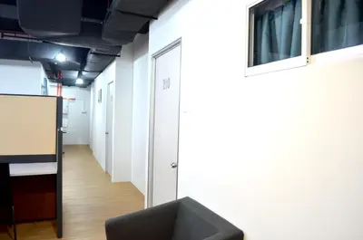 a hallway of an office with a chair and a podium at RED ROOM Kuala Lumpur in Kuala Lumpur