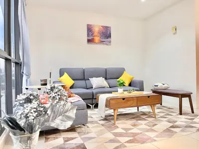 a living room with a couch and a coffee table at KL Gateway 2B2B Cozy apartment in Kuala Lumpur