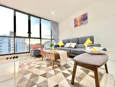 a living room with a couch and a table at KL Gateway 2B2B Cozy apartment in Kuala Lumpur