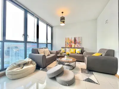 a living room with two couches and a table at KL Gateway 2B2B Cozy apartment in Kuala Lumpur