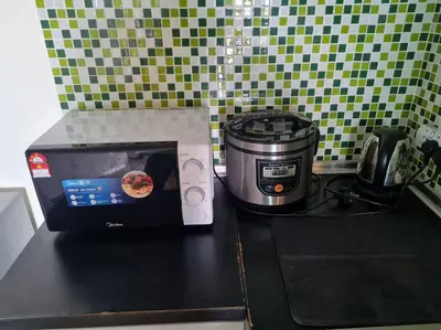 a microwave and a toaster on a kitchen counter at 1 min Next to LRT CHERAS 68 in Kuala Lumpur