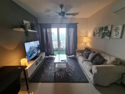 a living room with a couch and a tv at 1 min Next to LRT CHERAS 68 in Kuala Lumpur