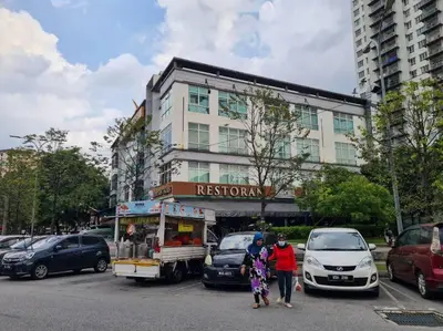 two people standing in a parking lot with a food truck at 1 min Next to LRT CHERAS 68 in Kuala Lumpur