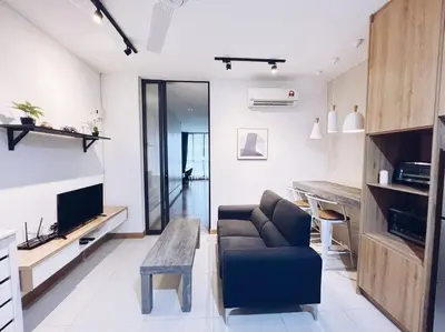 a living room with a couch and a table at PROMO CONNECTED TRAIN 1 Bedroom ABOVE MALL - 5 in Kuala Lumpur
