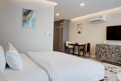 a hotel room with a white bed and a table at The Platinum 2 by MiuKy KLCC, Kuala Lumpur in Kuala Lumpur