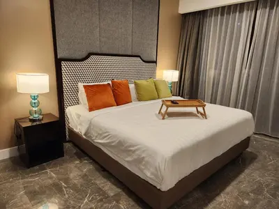 a bedroom with a bed with a table on it at The Platinum 2 by MiuKy KLCC, Kuala Lumpur in Kuala Lumpur