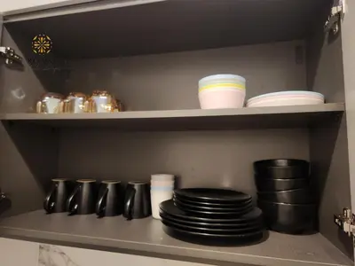 a shelf with plates and other dishes in a refrigerator at The Platinum 2 by MiuKy KLCC, Kuala Lumpur in Kuala Lumpur