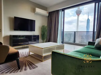 a living room with a couch and a tv at The Platinum 2 by MiuKy KLCC, Kuala Lumpur in Kuala Lumpur