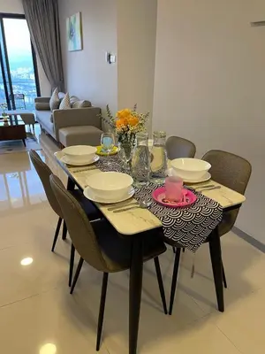 a dining room table with chairs and plates and a table at 7PAX Kepong DesaPark Publika MontKiara 100Mbps in Kuala Lumpur