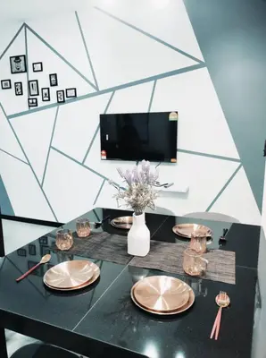 a black table with plates and a vase with flowers at Neu suites 007- 2 bedrooms klcc in Kuala Lumpur