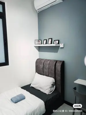 a bedroom with a bed and a shelf with pictures at Neu suites 007- 2 bedrooms klcc in Kuala Lumpur